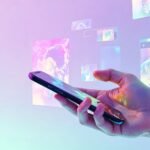 Hand holding a cell phone with technology aesthetic screens